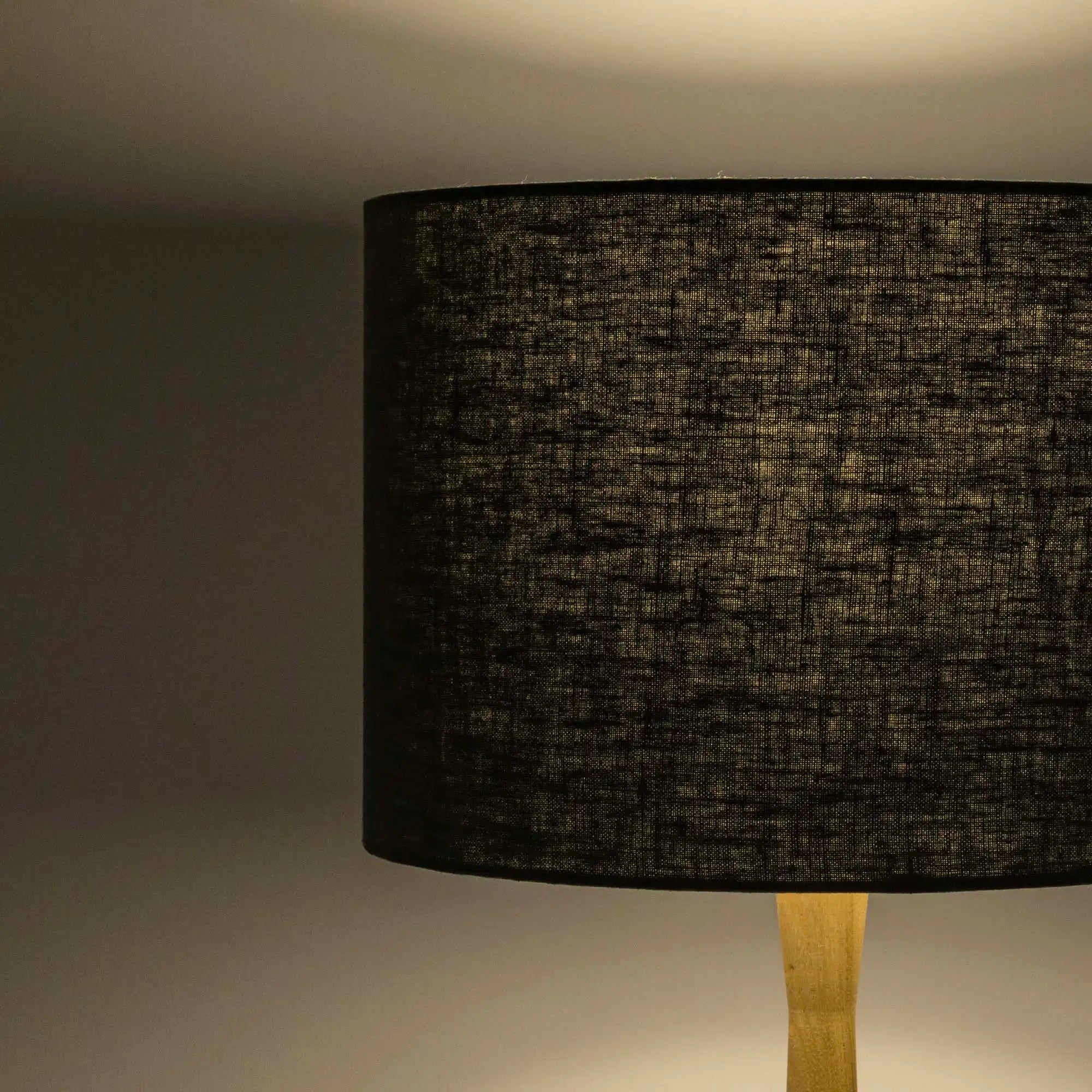 Dark green lampshade in textured linen illuminated