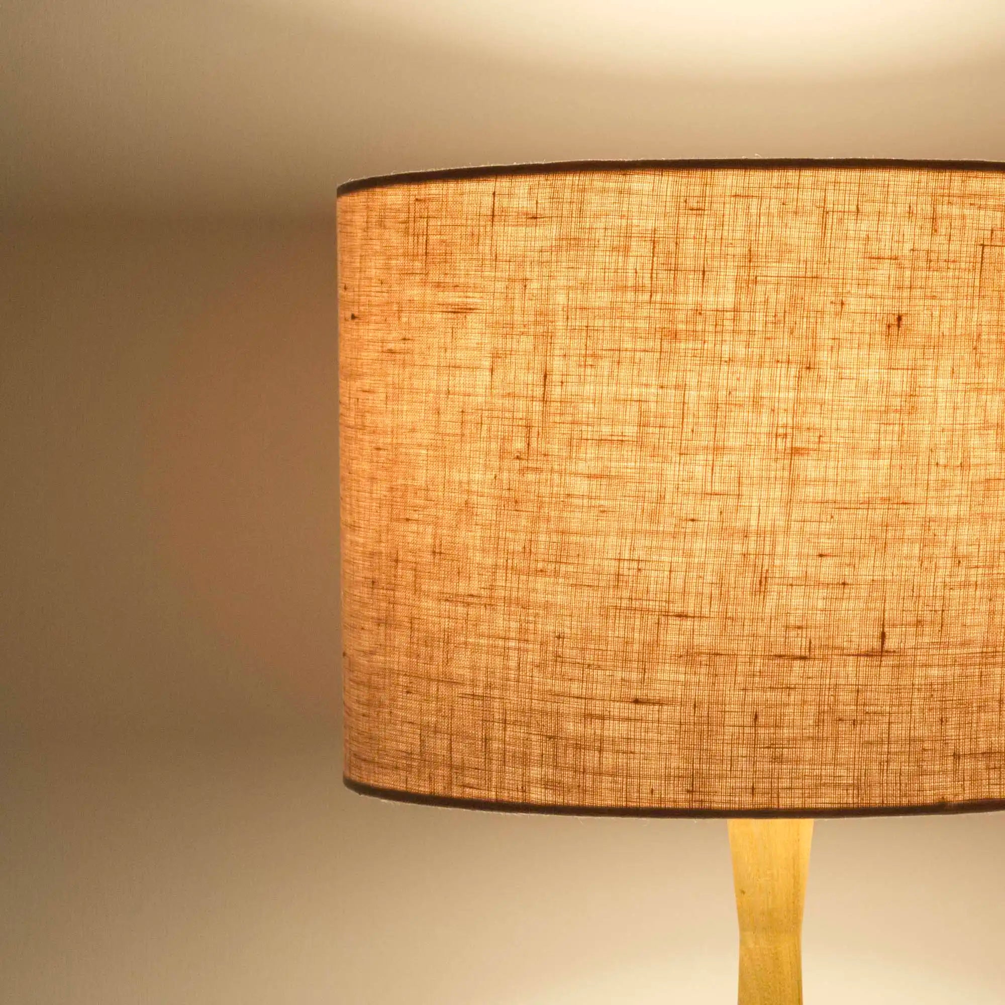 Blush pink lampshade in textured linen illuminated