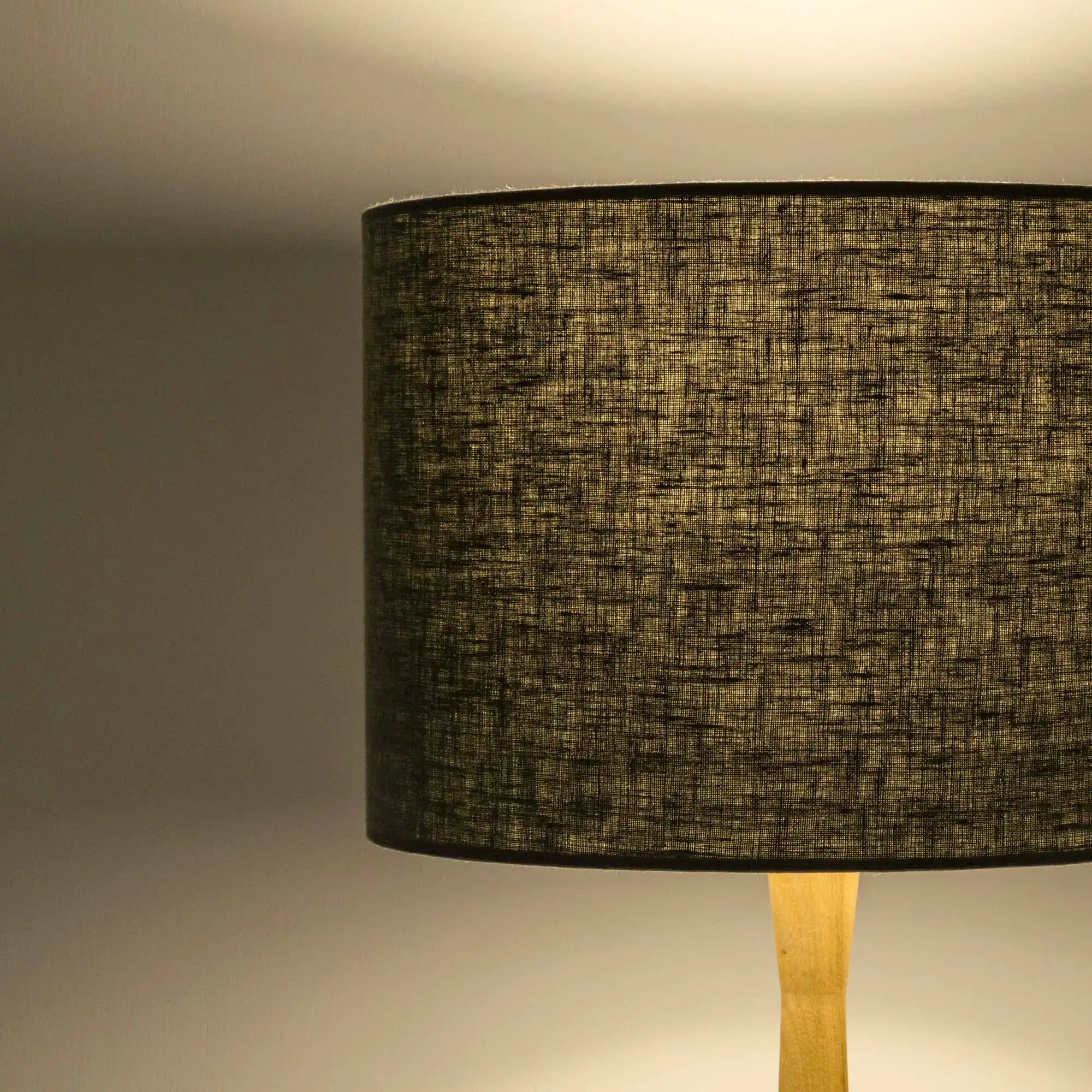 Sage green lampshade in textured linen illuminated