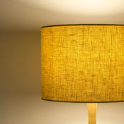 Honey yellow lampshade in textured linen illuminated