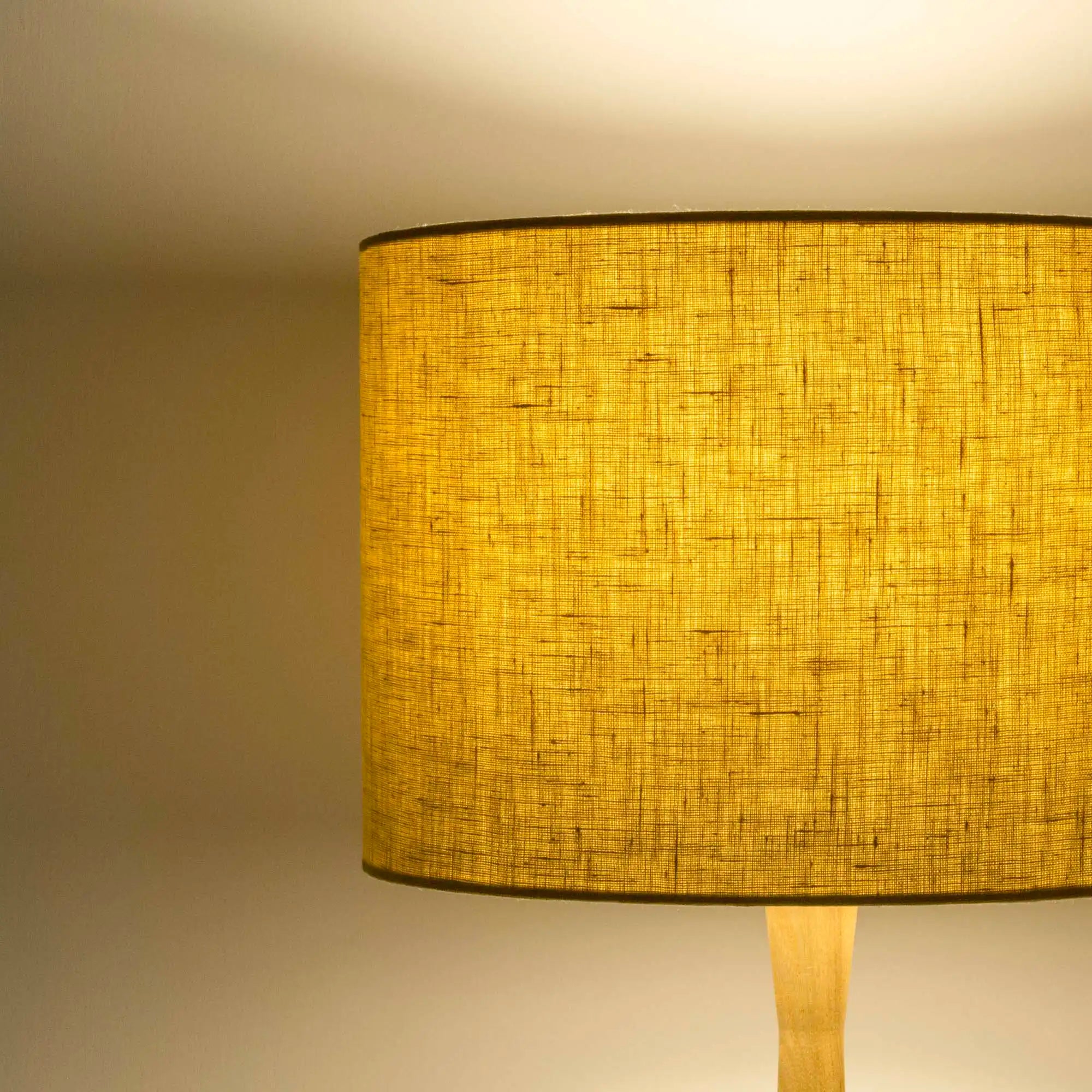 Honey yellow lampshade in textured linen illuminated