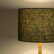 Moss green lampshade in textured linen illuminated