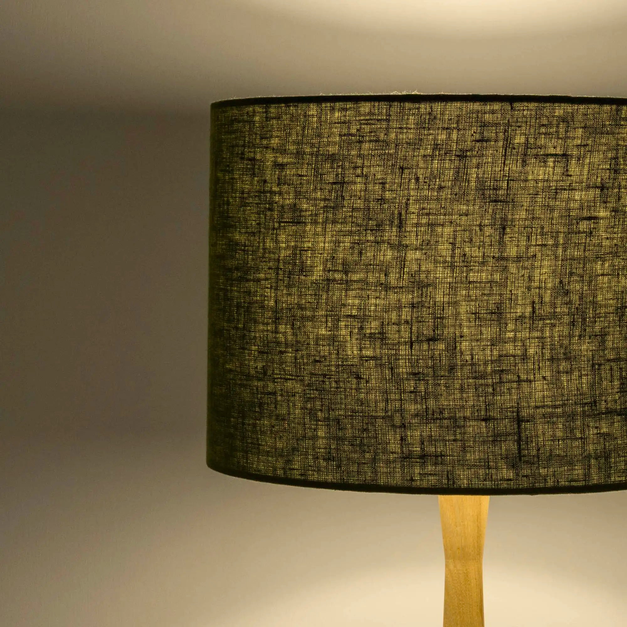 Moss green lampshade in textured linen illuminated