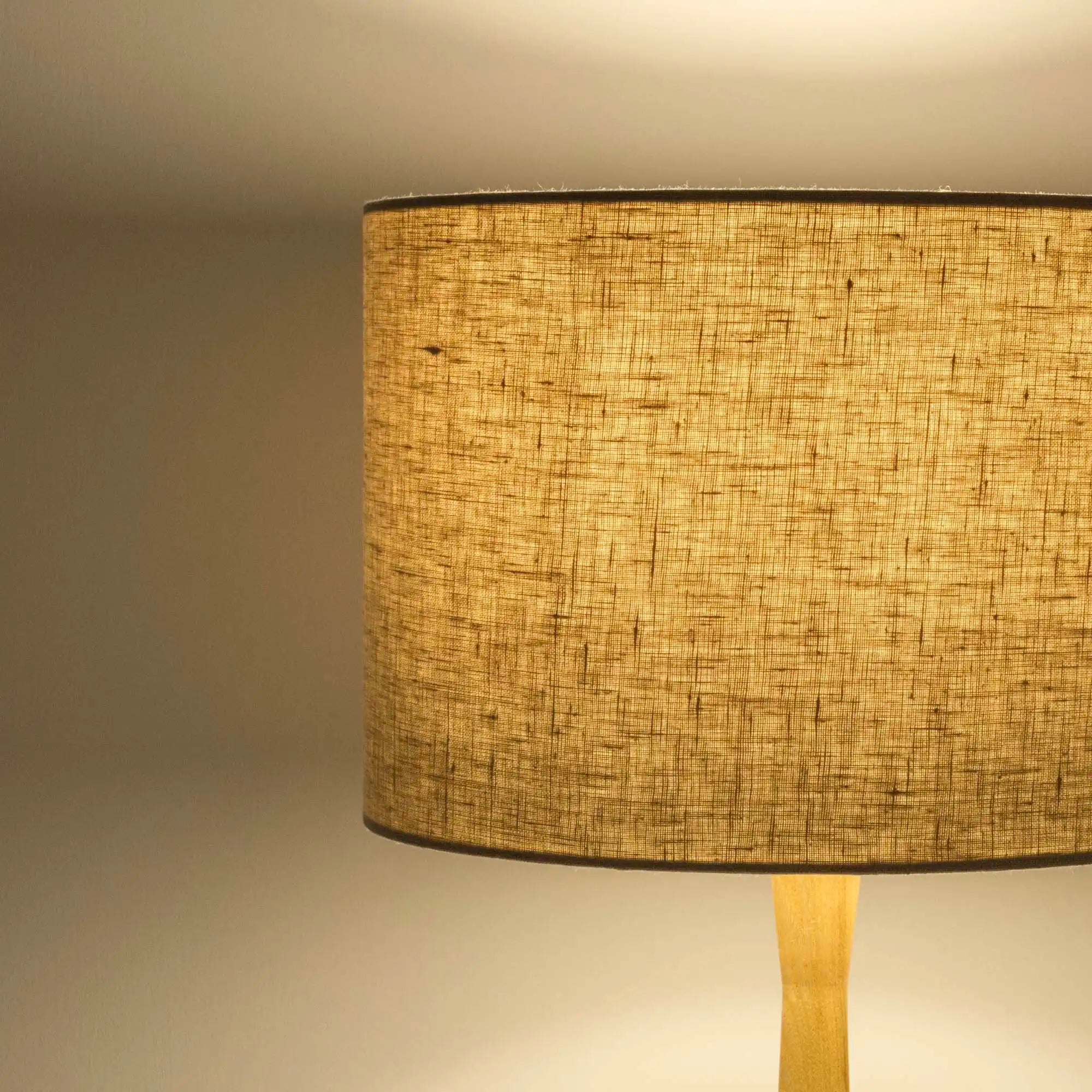 Oatmeal lampshade in textured linen illuminated
