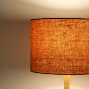 Pumpkin orange lampshade in textured linen illuminated