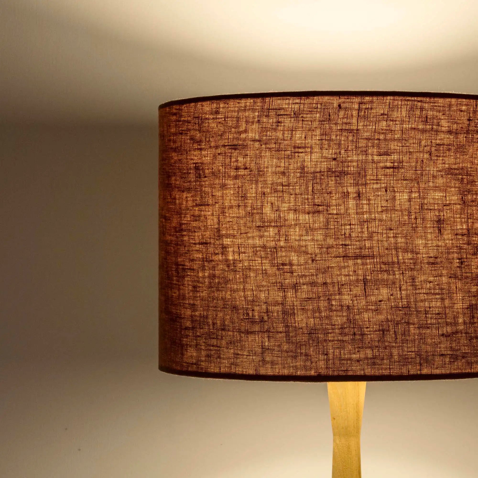 Terracotta lampshade in textured linen illuminated