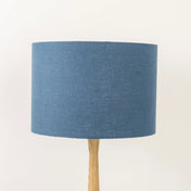 Dusty blue lampshade made from textured linen on wooden stand