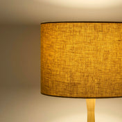 Mustard yellow lampshade in textured linen illuminated 