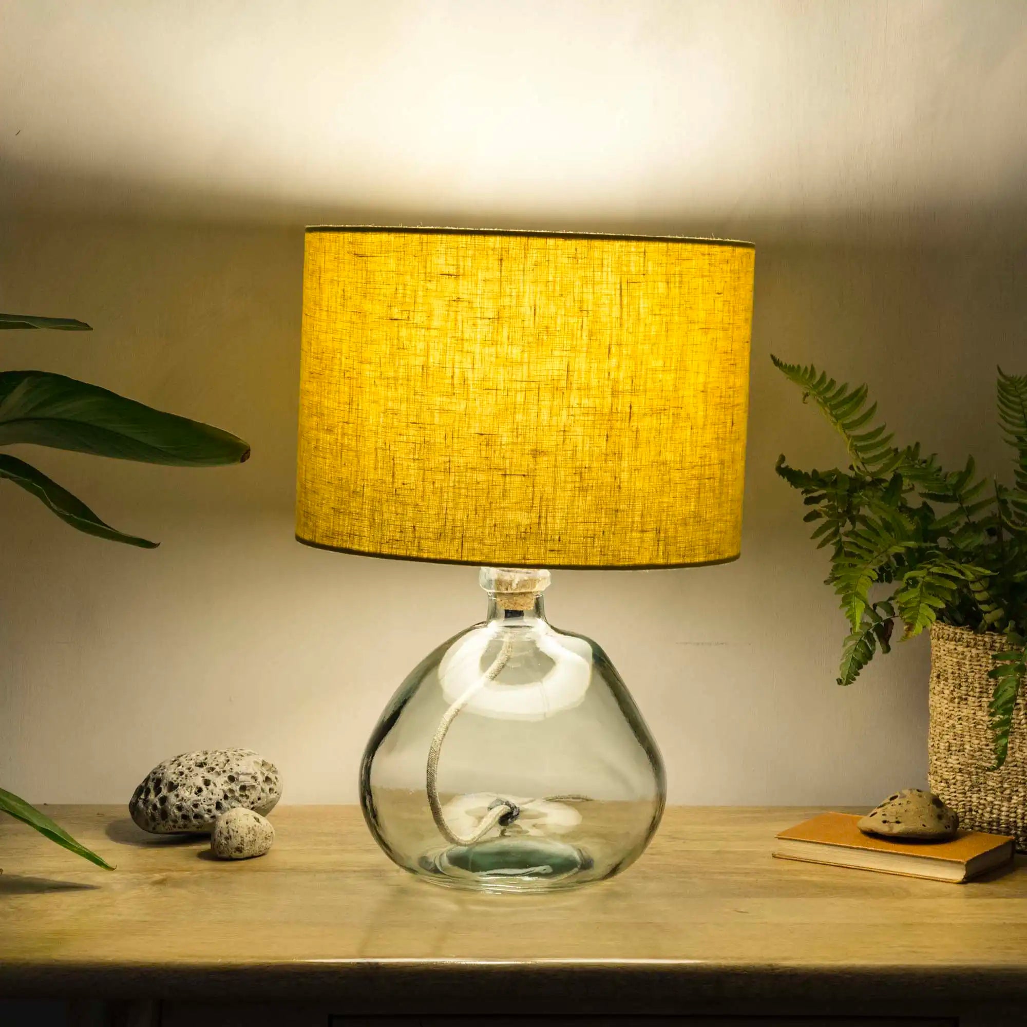 Honey yellow linen lampshade with recycled glass base illumiated