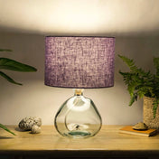 Lavender lampshade made from textured linen illuminated on recycled glass table lamp