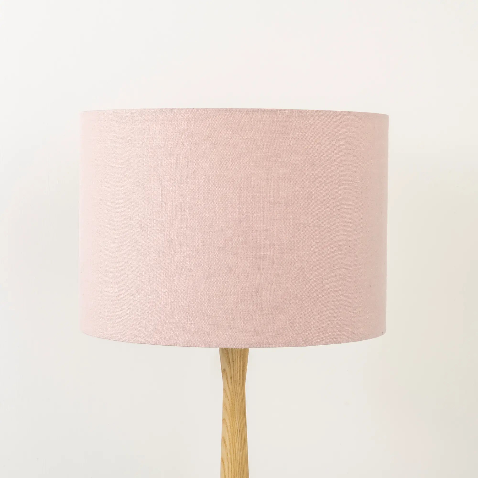 Light dusty pink lampshade made from textured linen on wooden stand