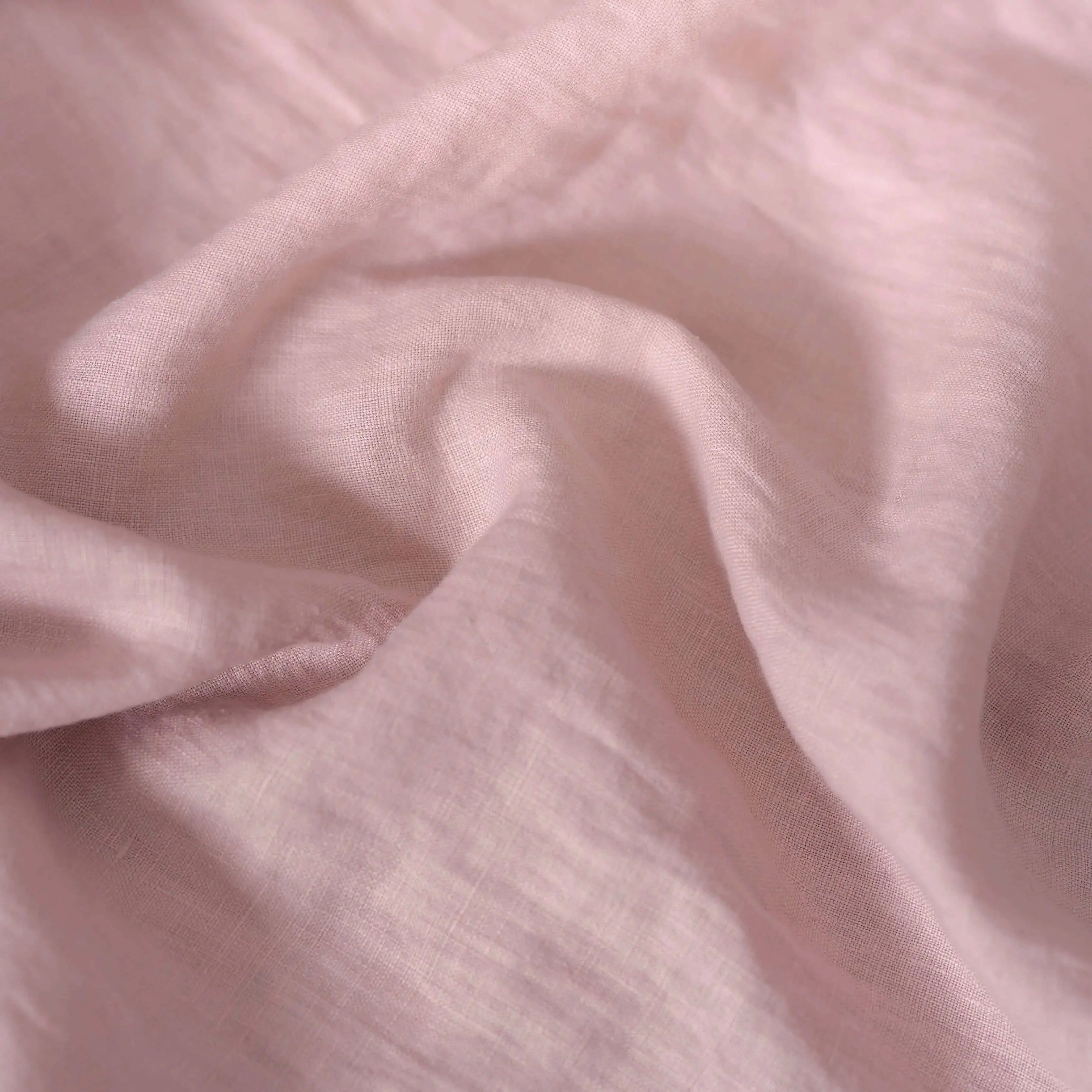 Light Dusty Pink linen fabric, crumpled to show its natural texture, washed European flax