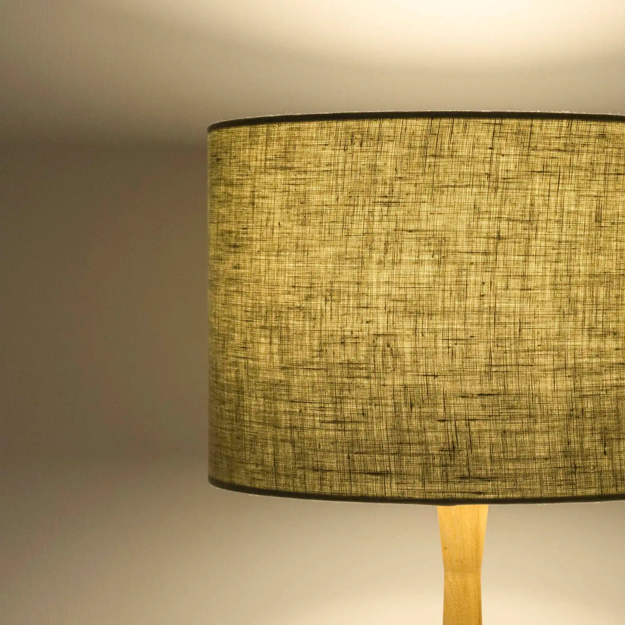 Light sage lampshade in textured linen illuminated 