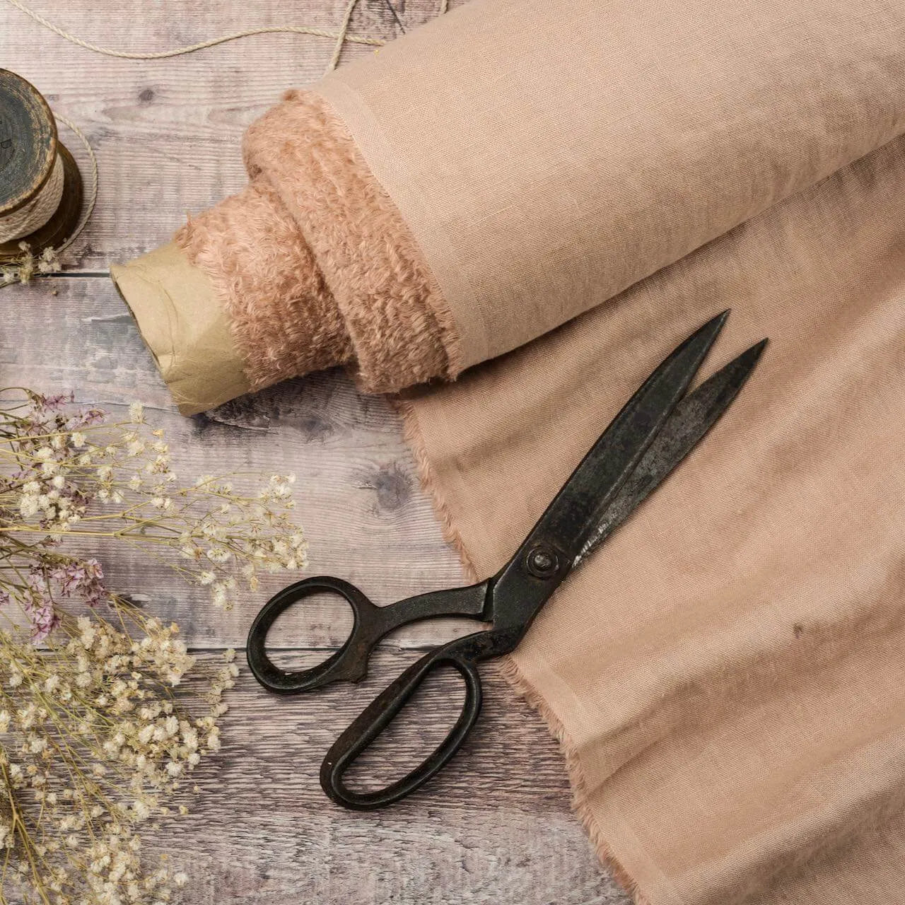 Pastel Pink Nude linen fabric, ready to cut, with scissors, thread bobbins and flowers