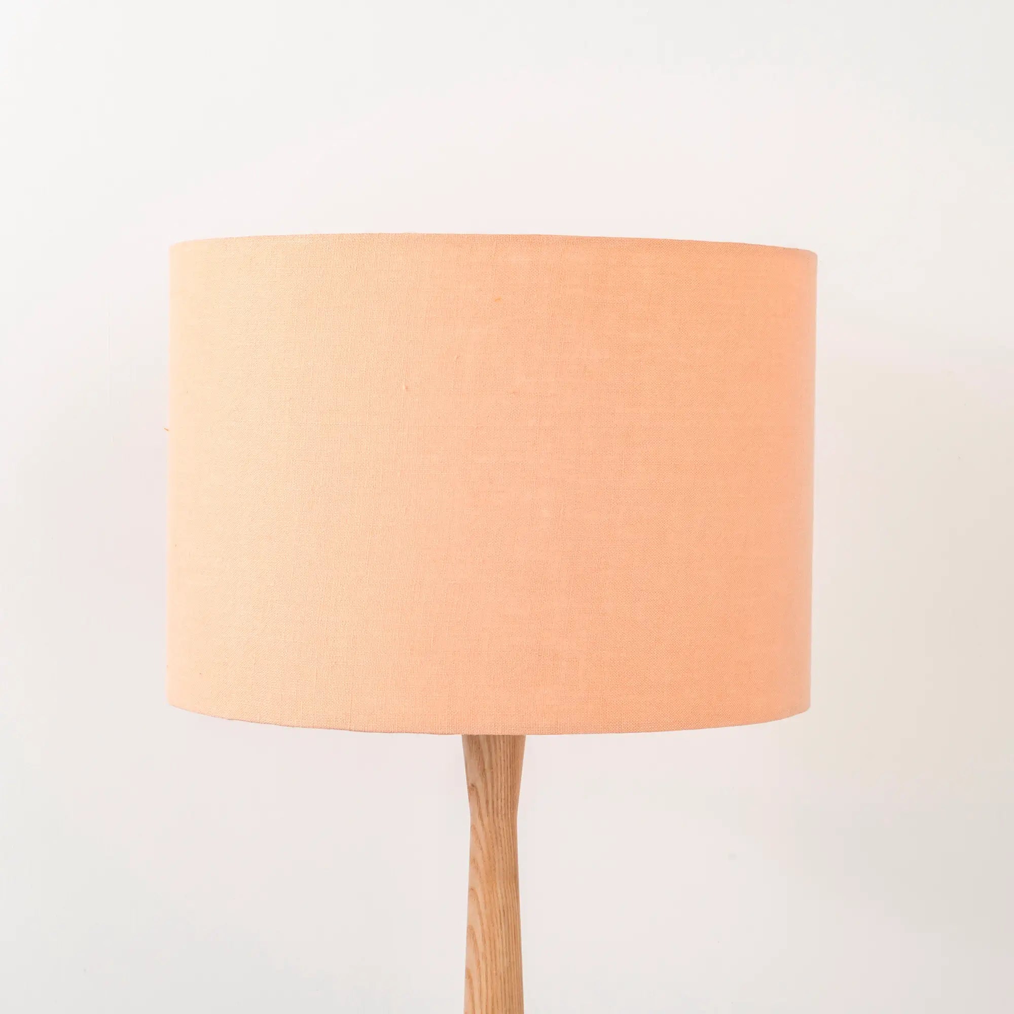 peach-linen-lampshade-wooden-table-lamp.webp