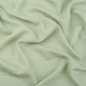 Pistachio Green linen fabric, crumpled to show its natural texture, washed European flax