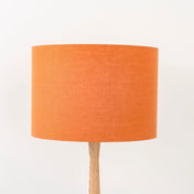 Pumpkin orange lampshade made from textured linen on wooden stand