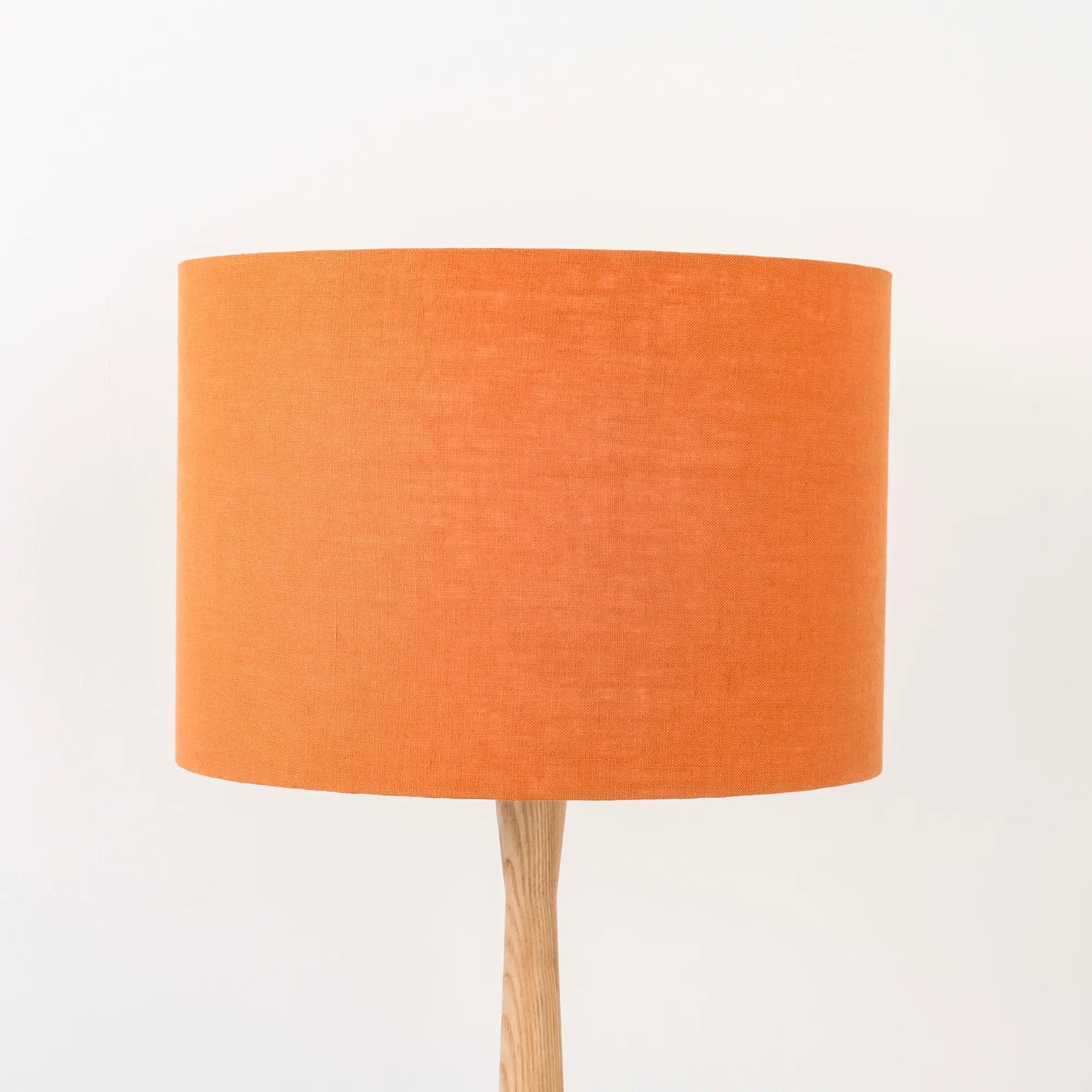 Pumpkin orange lampshade made from textured linen on wooden stand