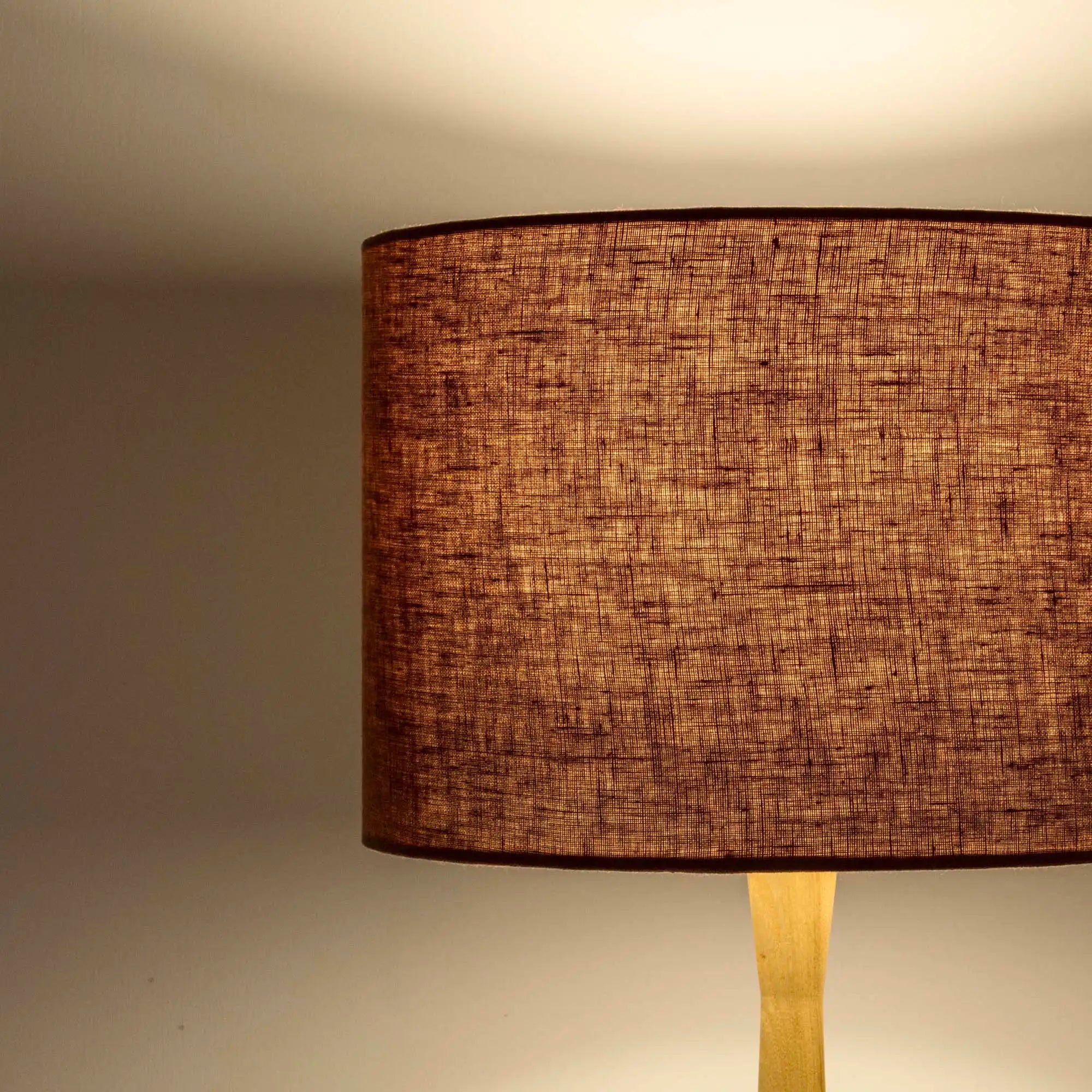 Terracotta lampshade in textured linen illuminated 