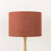 Terracotta lampshade made from textured linen on wooden stand