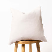 Coconut milk linen cushion cover on wooden stool