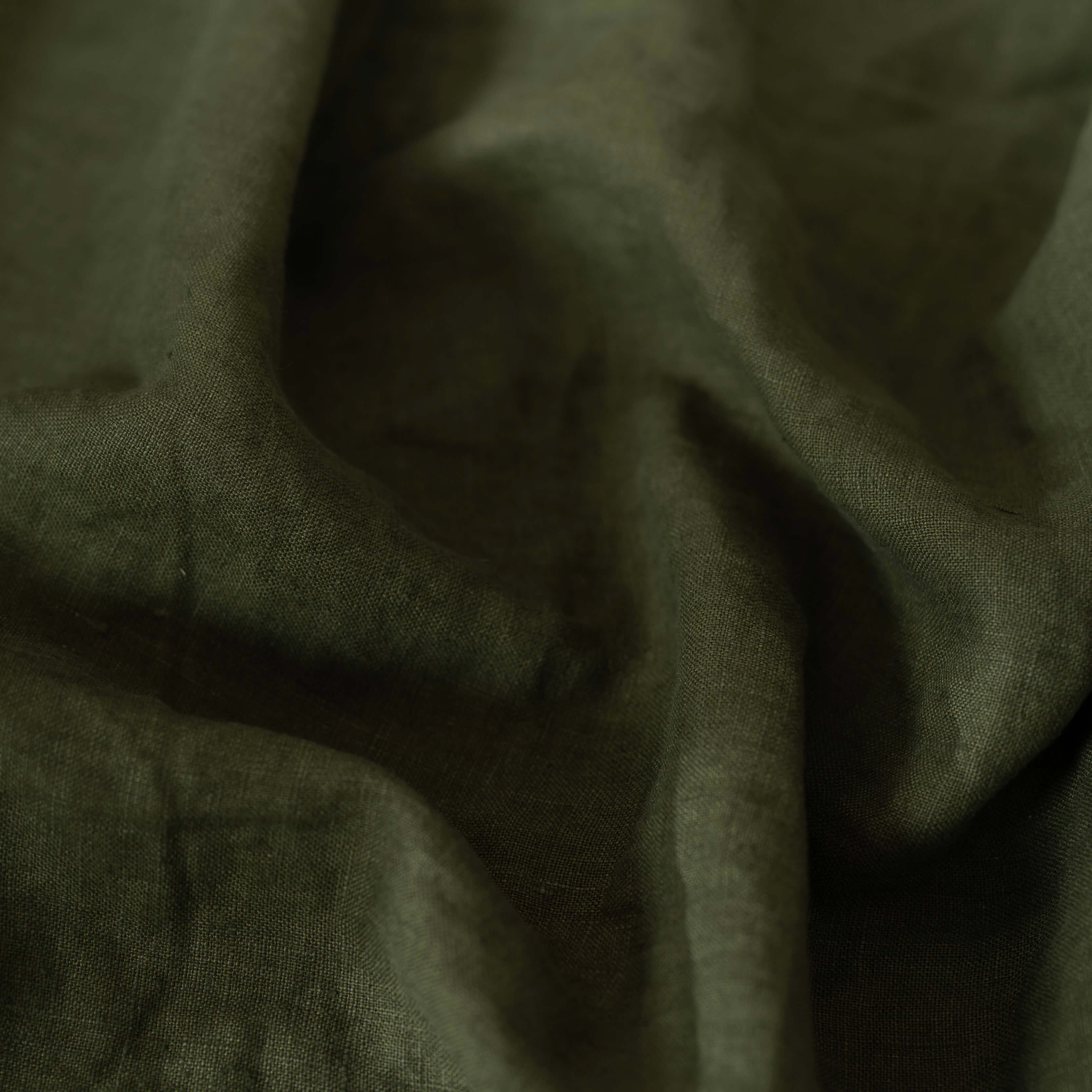 Avocado green linen fabric scrunched up