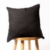 Black linen cushion cover on wooden stool