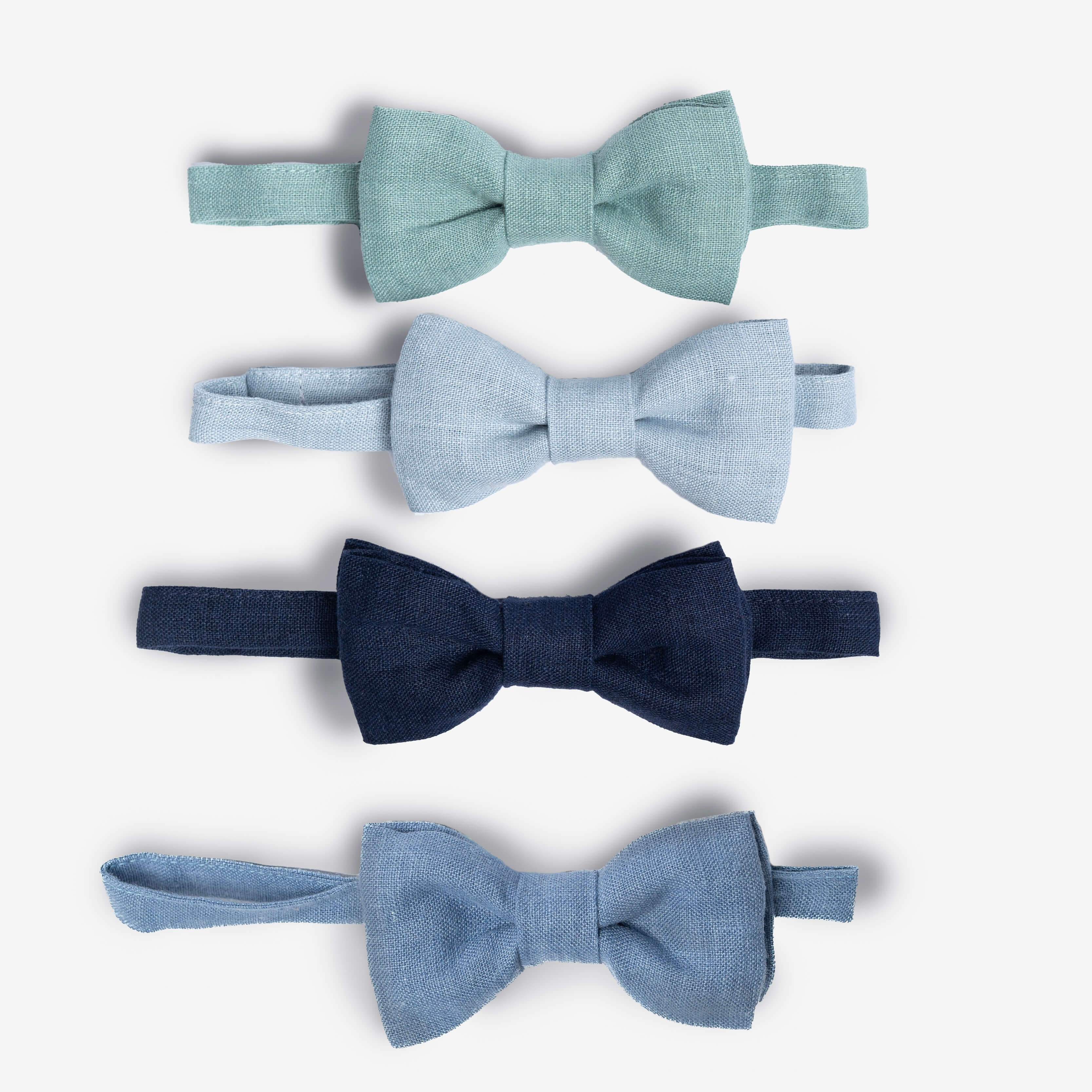 Collection of blue linen bow ties in turquoise, pale, navy and dusty blue