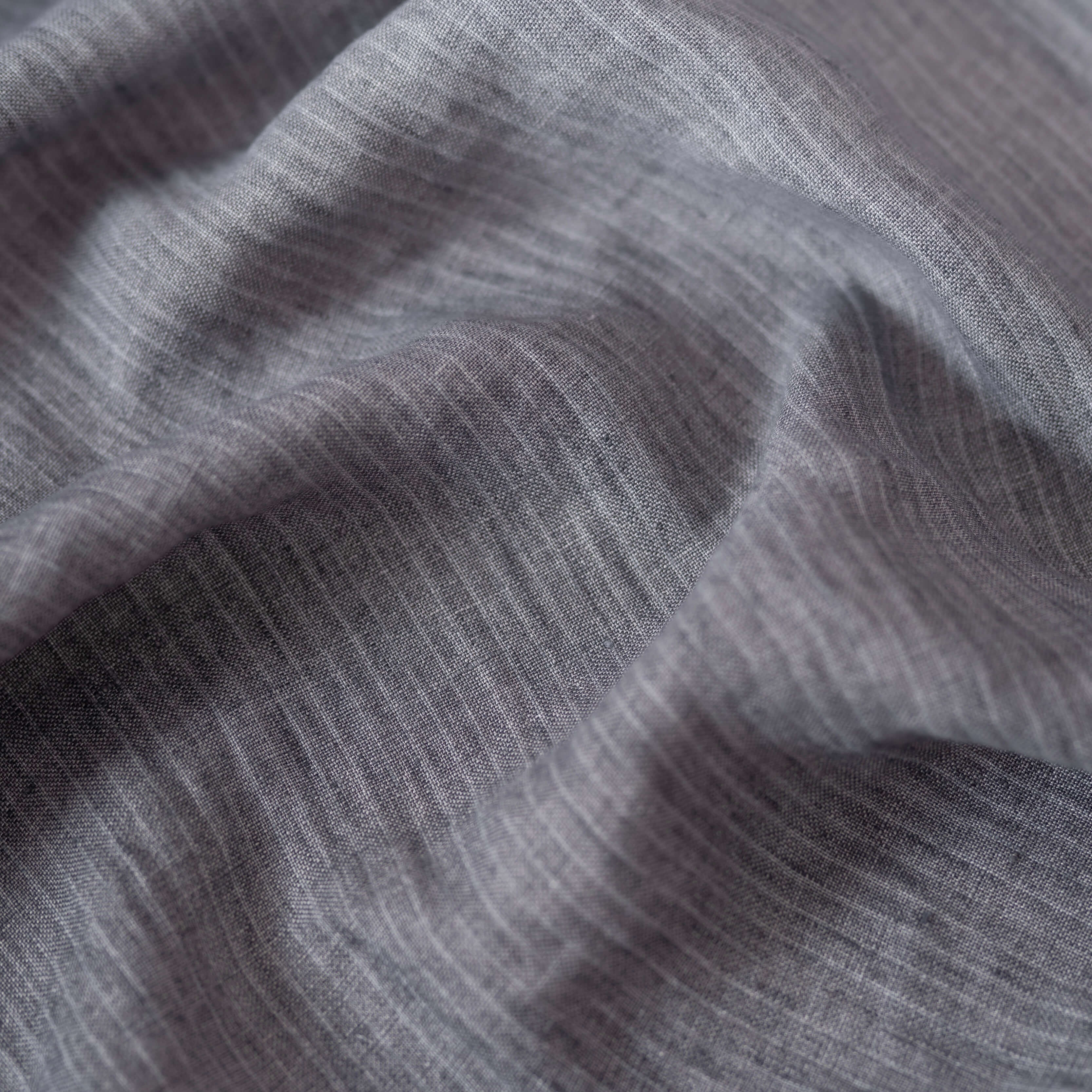 Grey Stripes Mélange linen fabric, crumpled to show its natural texture, washed European flax