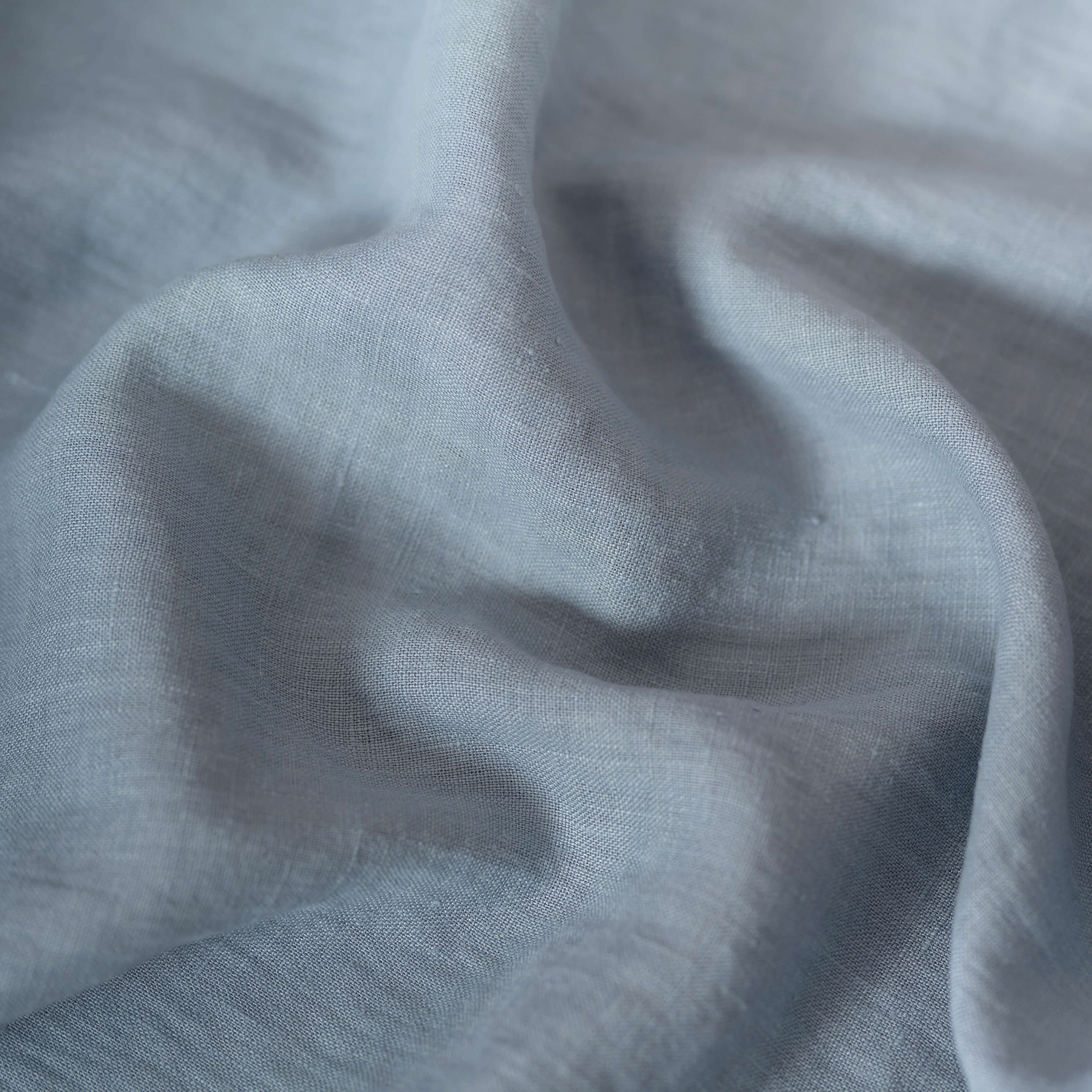 Blue Grey linen fabric, crumpled to show its natural texture, washed European flax
