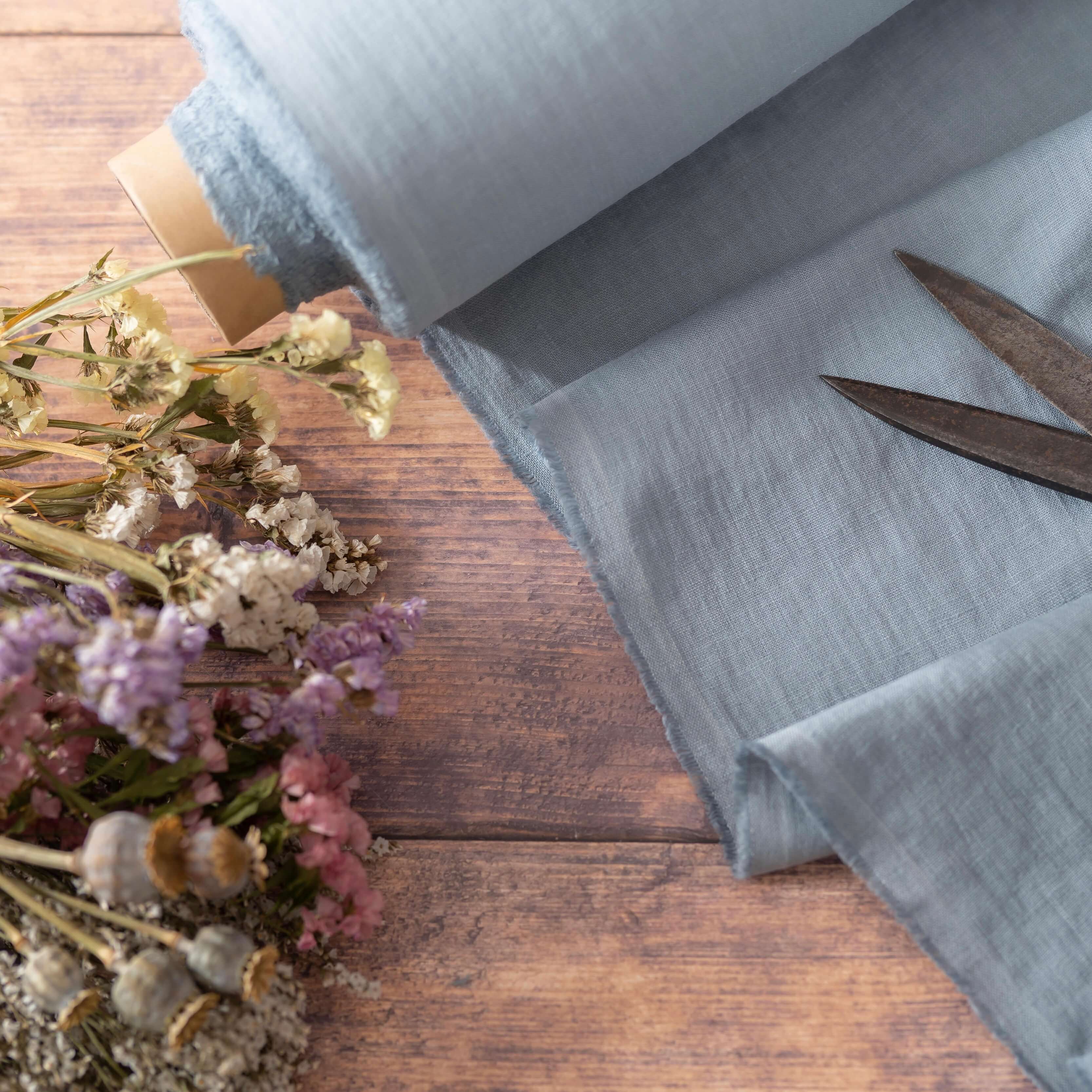 Blue Grey linen fabric, ready to cut, with scissors and flowers