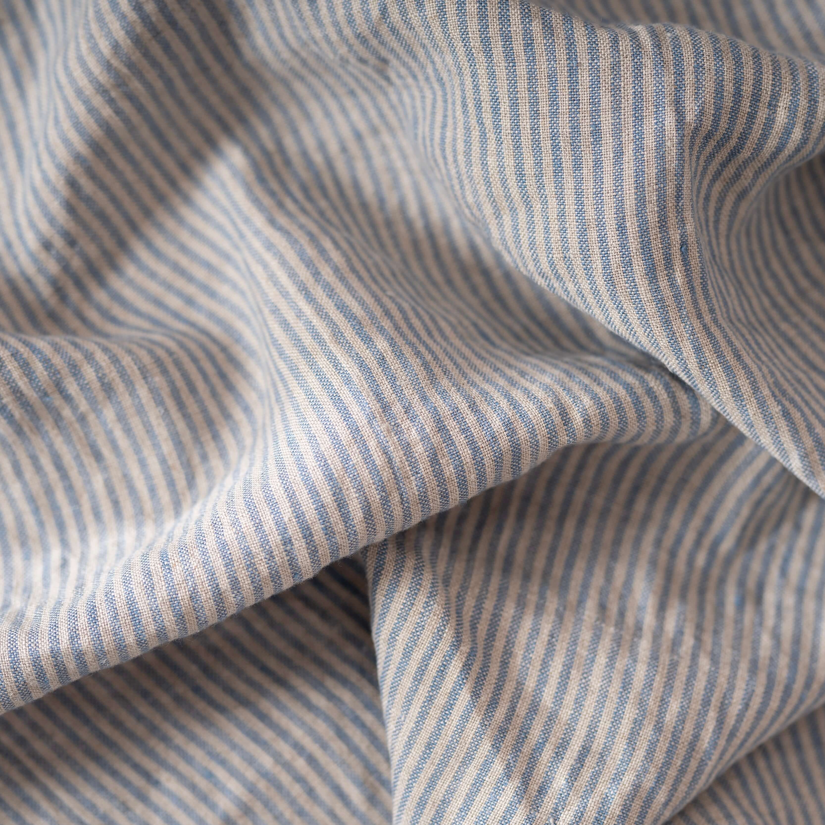 Blue Stripes linen fabric, crumpled to show its natural texture, washed European flax