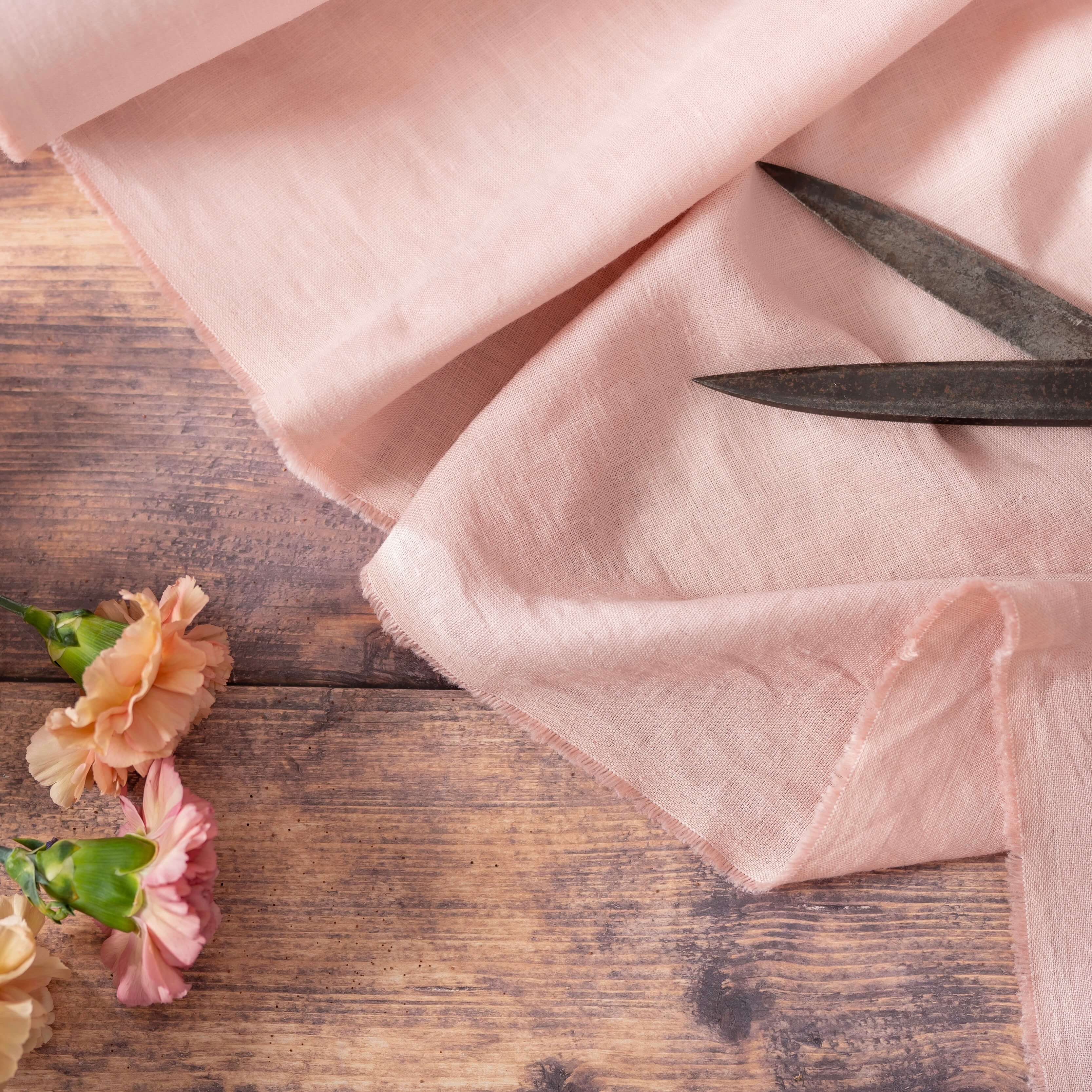 Blush Pink linen fabric, ready to cut, with scissors and flowers