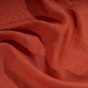 Brick Red linen fabric, crumpled to show its natural texture, washed European flax