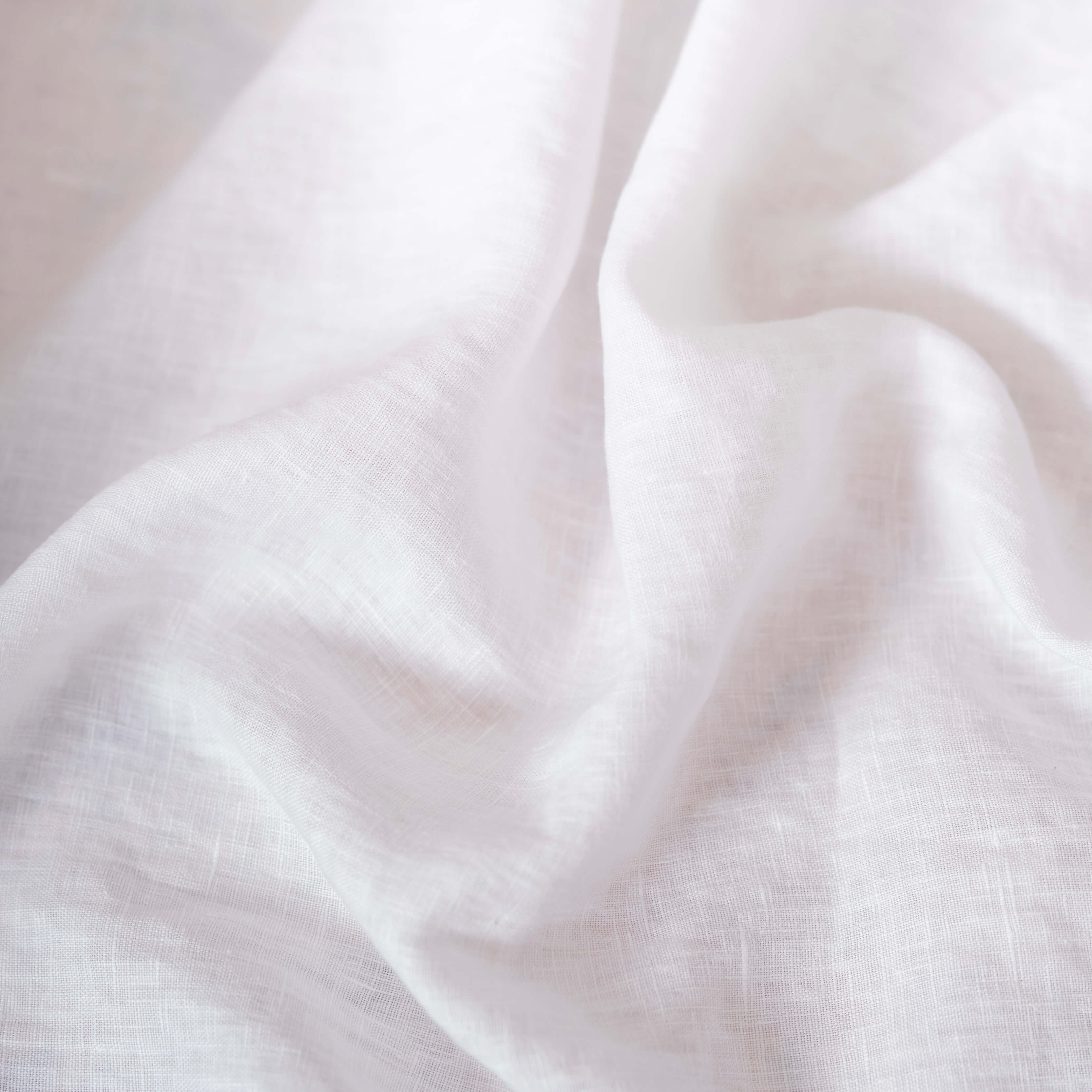 Bright White linen fabric, crumpled to show its natural texture, washed European flax