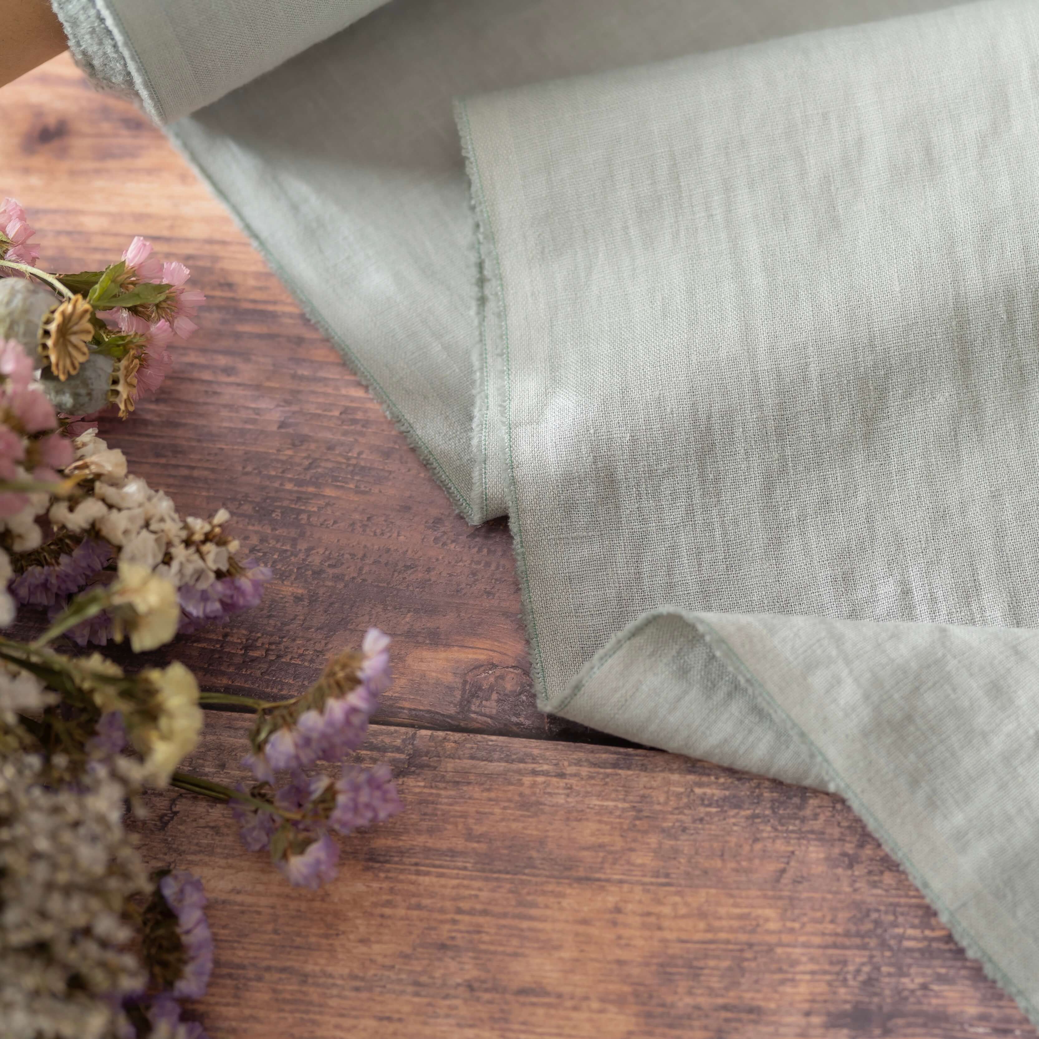 Dark Mint Green linen fabric, ready to cut, with scissors, thread bobbins and flowers
