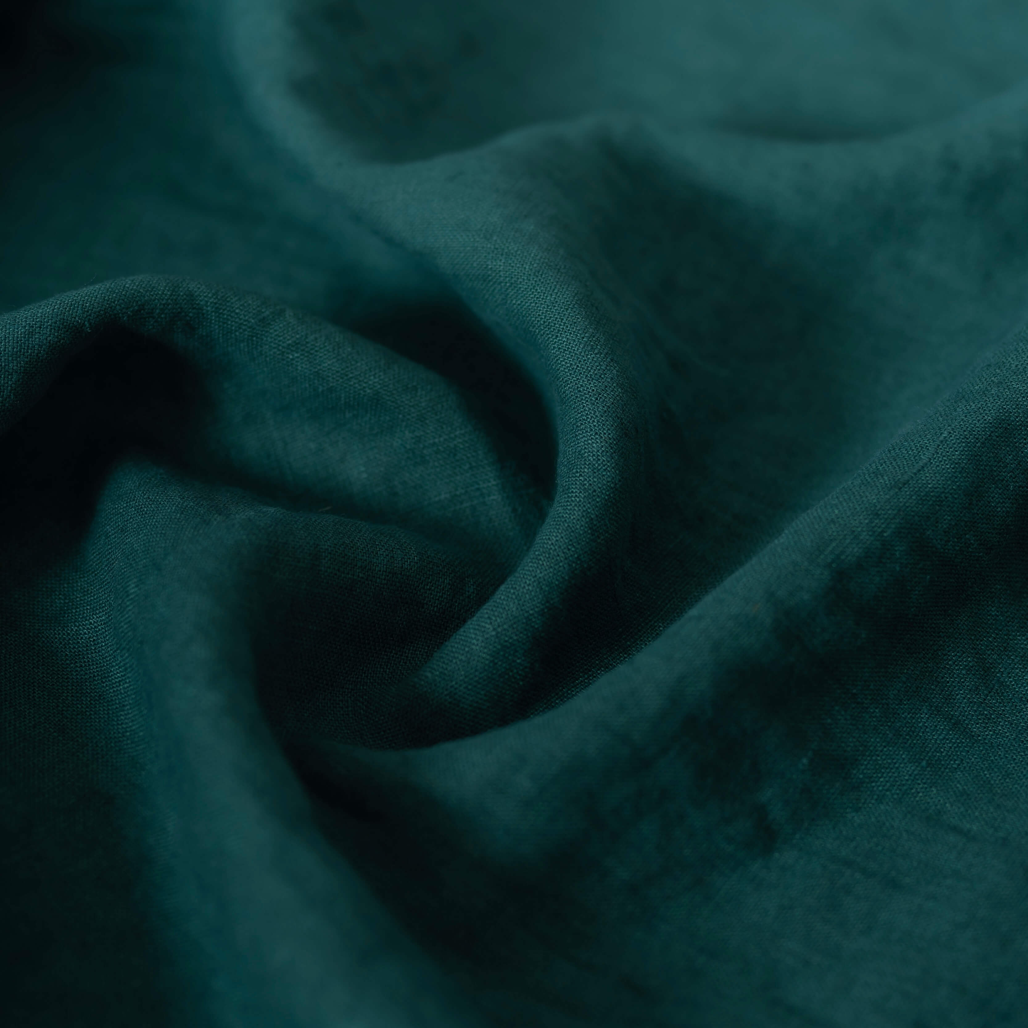Dark Forest Green linen fabric, crumpled to show its natural texture, washed European flax