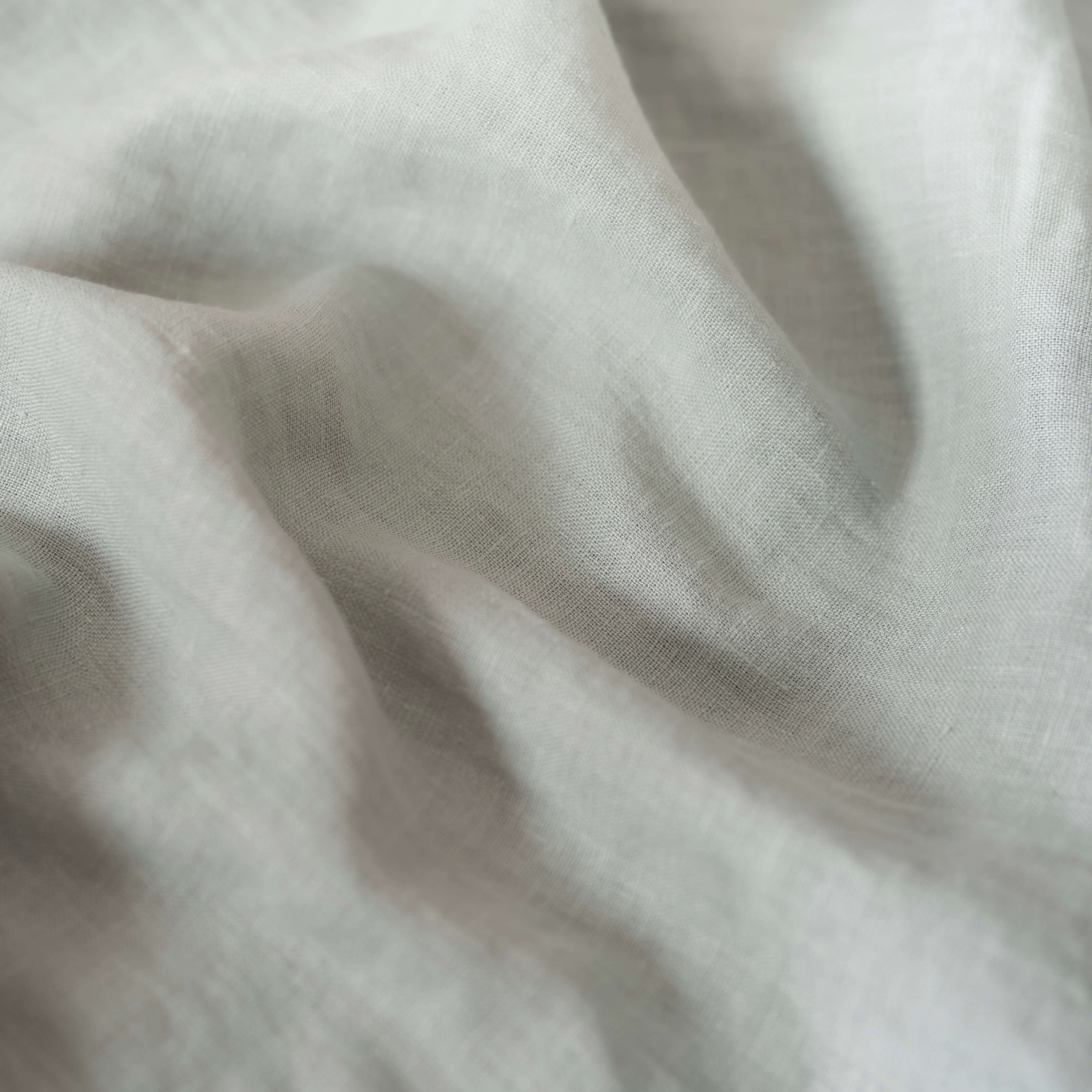 Dark Mint Green linen fabric, crumpled to show its natural texture, washed European flax