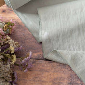 Dark Mint Green linen fabric, ready to cut, with scissors, thread bobbins and flowers