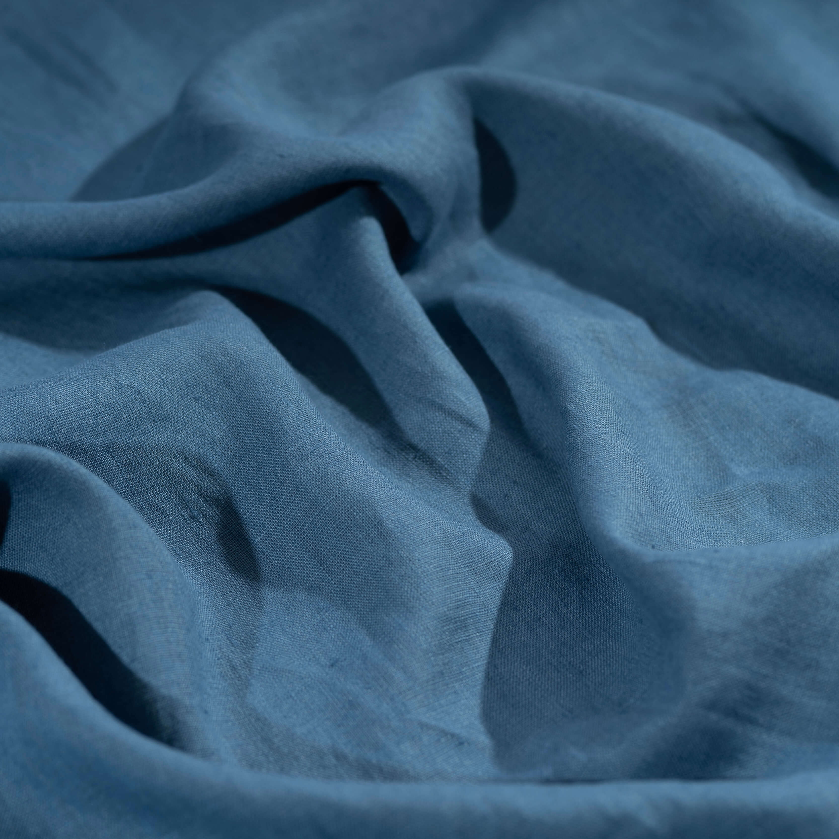 Dusty Blue linen fabric, crumpled to show its natural texture, washed European flax