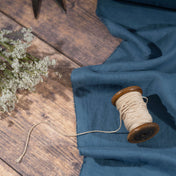 Dusty Blue linen fabric, ready to cut, with scissors, thread bobbins and flowers