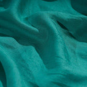 Emerald Green linen fabric, crumpled to show its natural texture, washed European flax