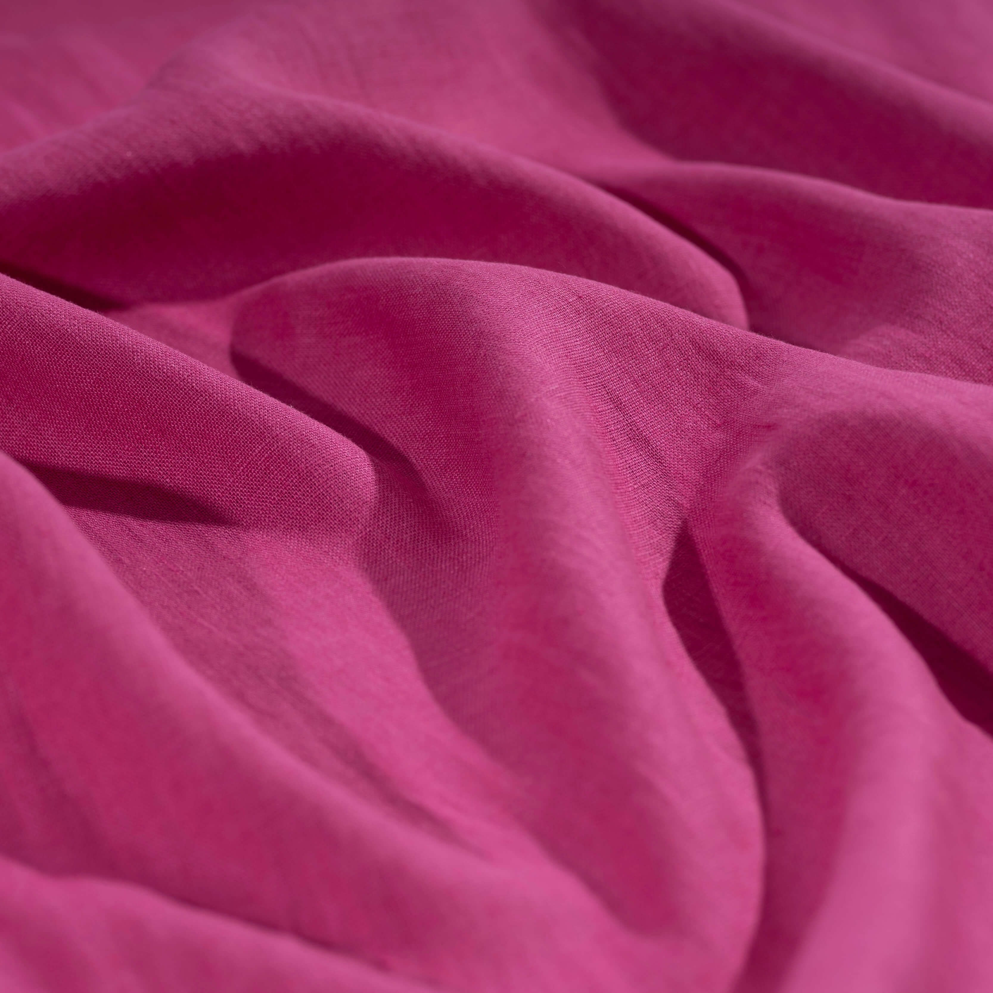 Fuchsia Pink linen fabric, crumpled to show its natural texture, washed European flax