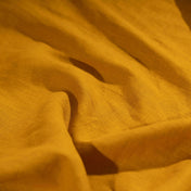 Golden Mustard Yellow linen fabric, crumpled to show its natural texture, washed European flax
