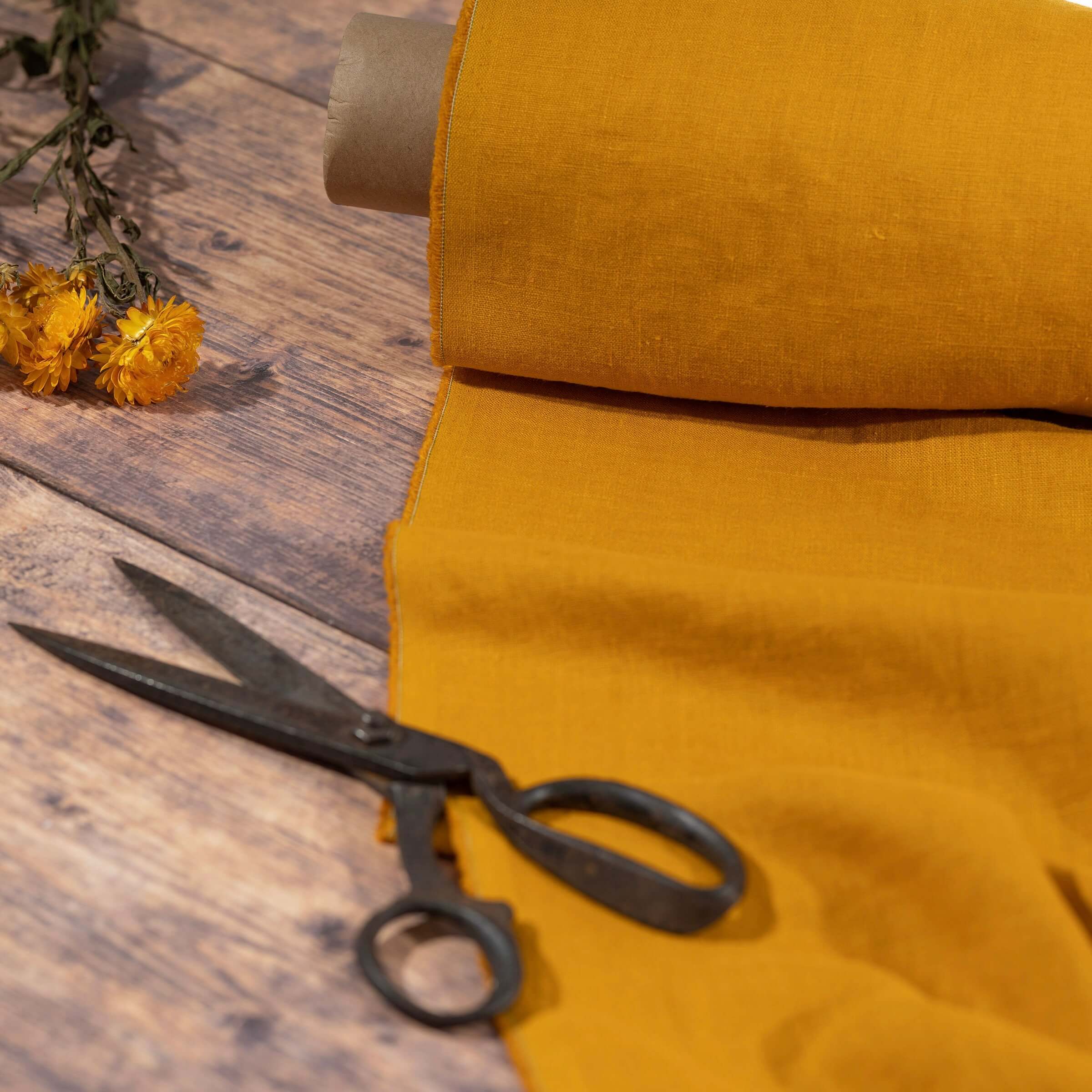 Golden Mustard Yellow linen fabric, ready to cut, with scissors, thread bobbins and flowers