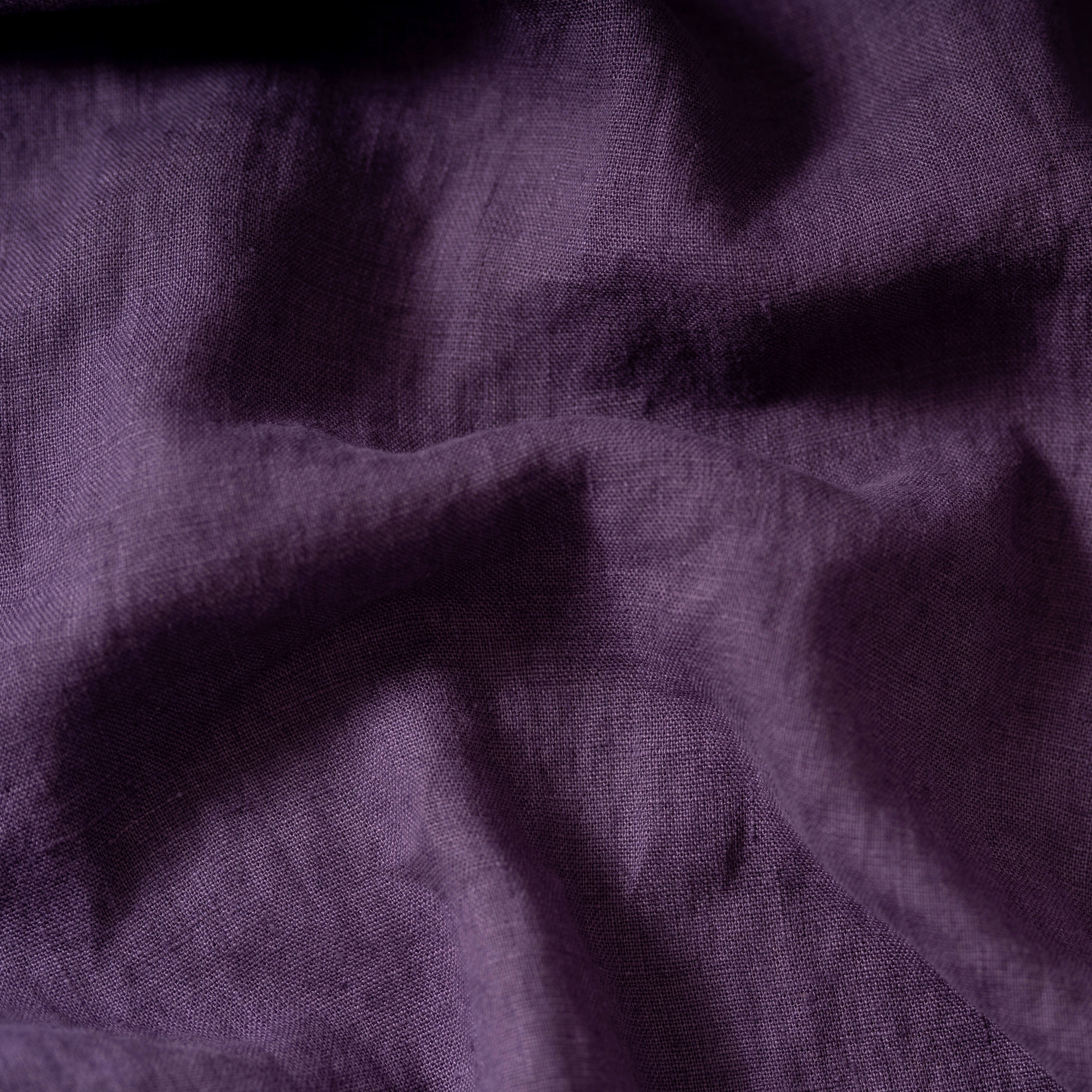 Grape Purple linen fabric, crumpled to show its natural texture, washed European flax