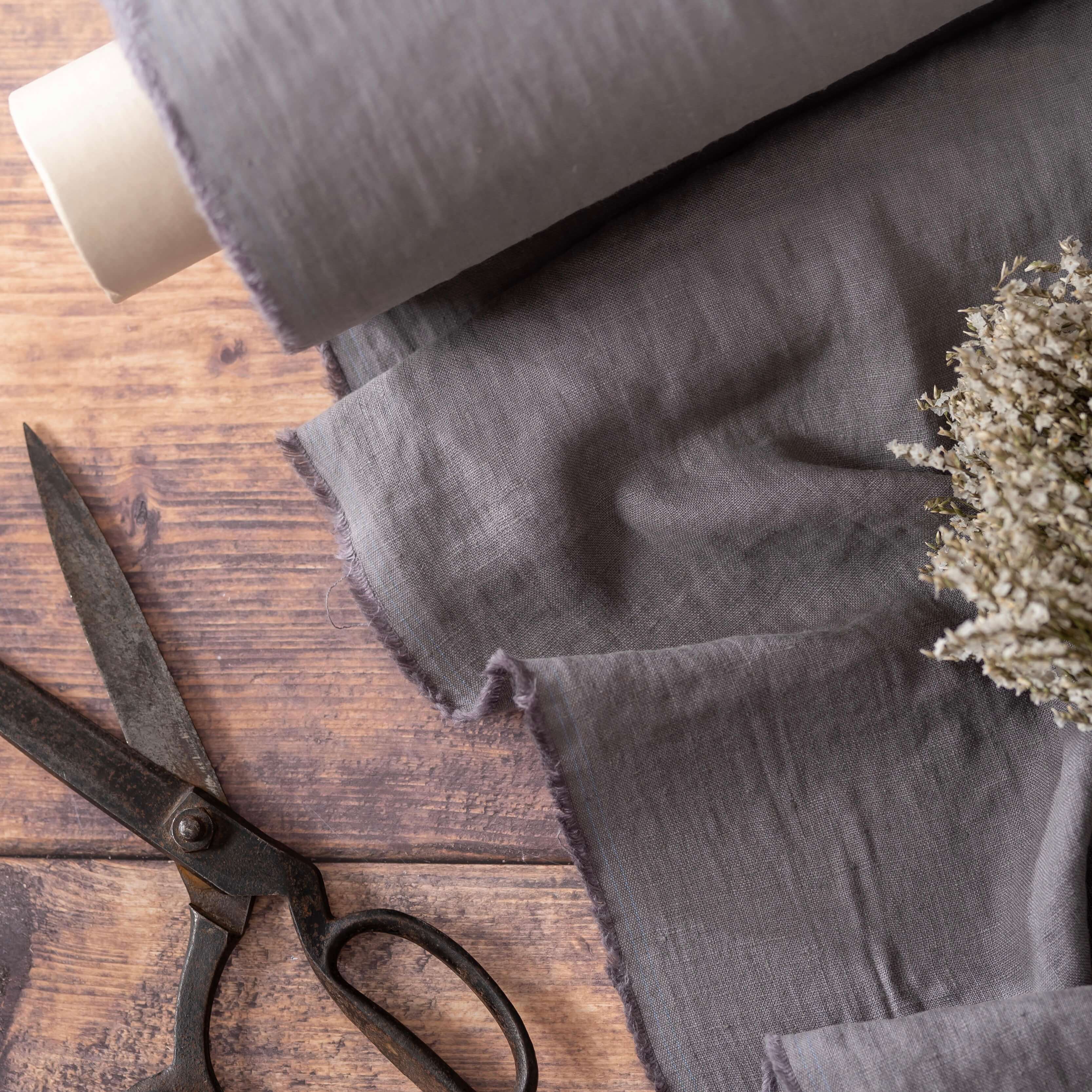 Graphite Grey linen fabric, ready to cut, with scissors and dried flowers