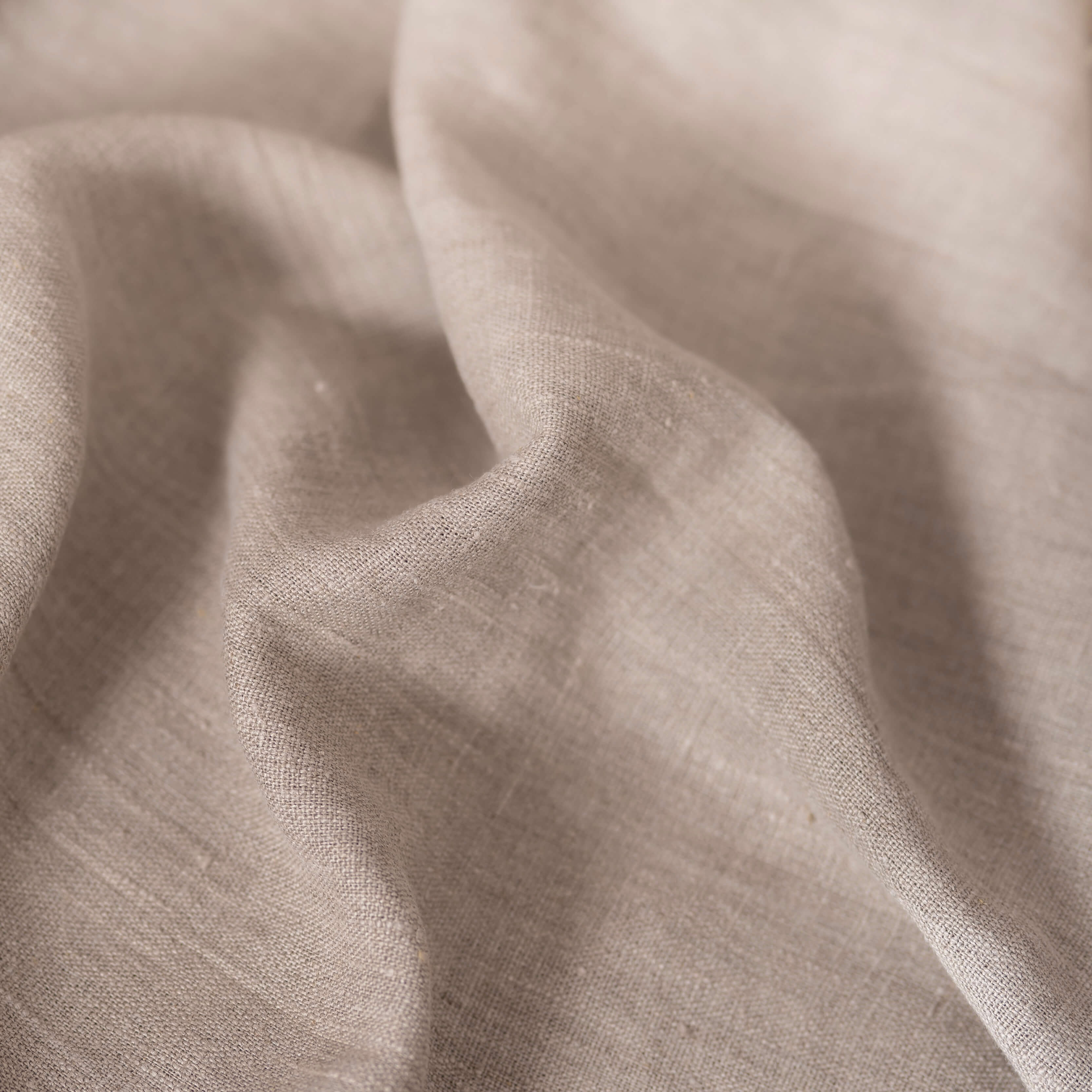 Heavyweight natural linen fabric, crumpled to show its natural texture, washed European flax