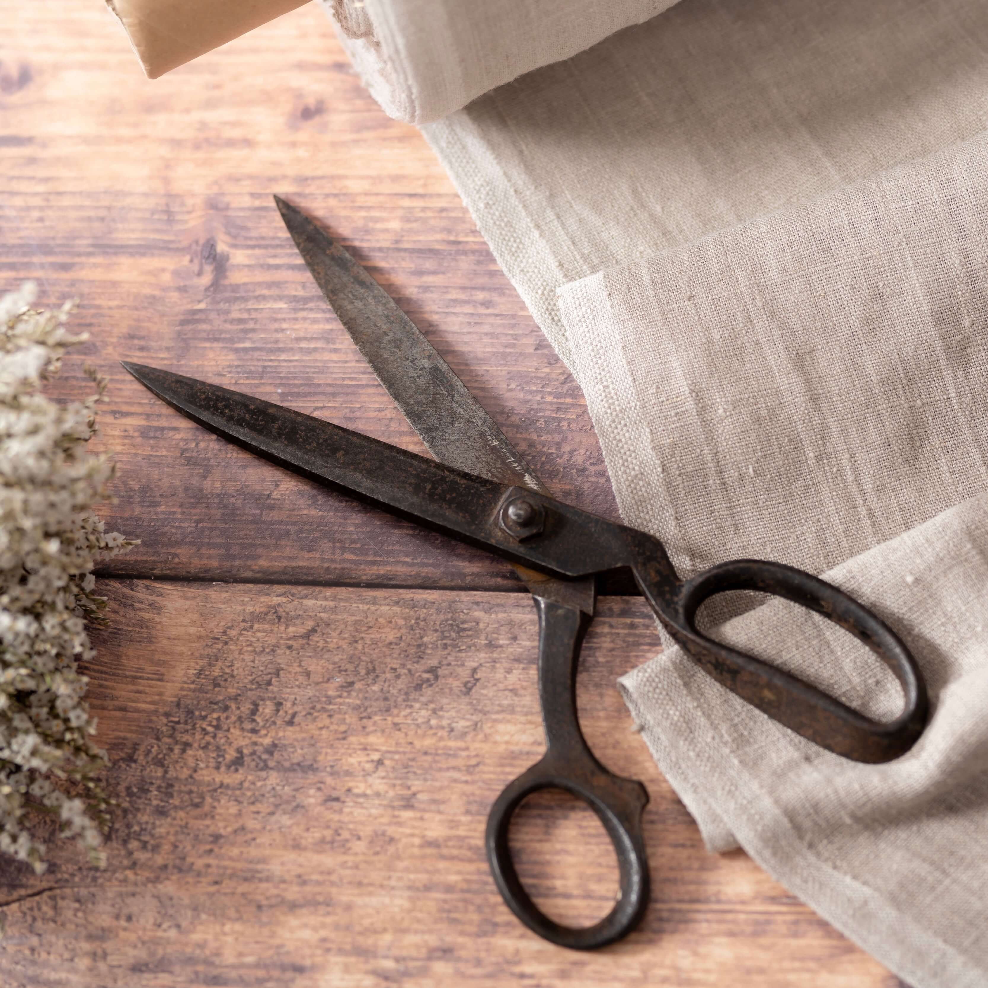 Natural linen fabric, ready to cut, with scissors and dried flowers