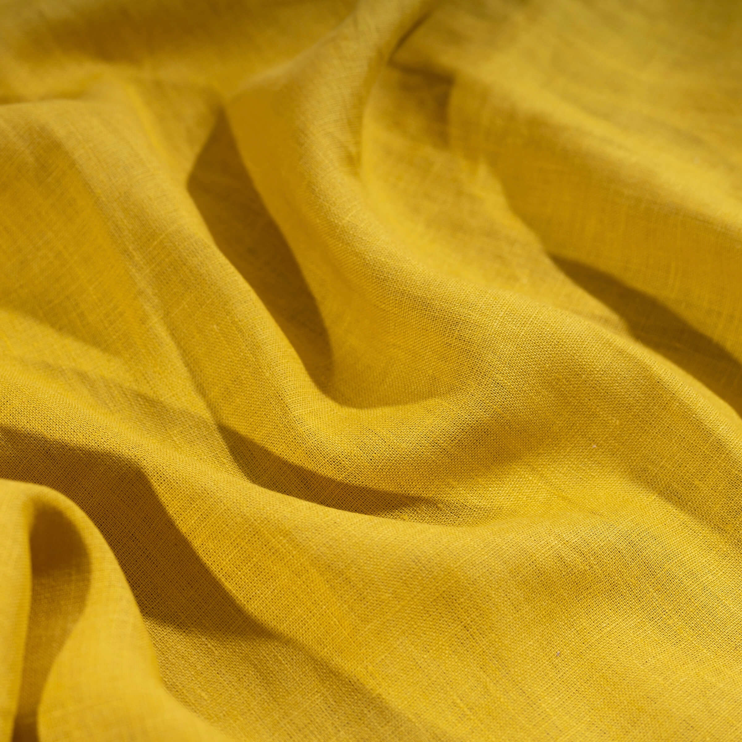 Honey Yellow linen fabric, crumpled to show its natural texture, washed European flax